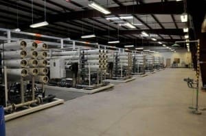A room full of water treatment equipment in a warehouse managed by MGC Contractors.