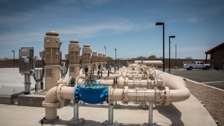 A group of pipes and valves in a parking lot.