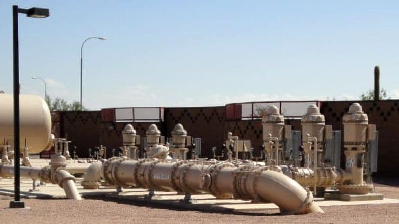 A large group of pipes in front of a building.